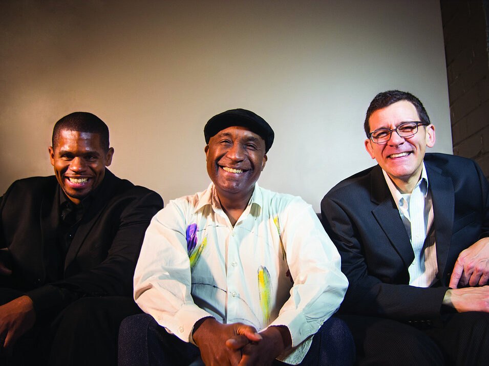 Bobby Floyd, Derek DiCenzo and Reggie Jackson smiling together in a studio portrait