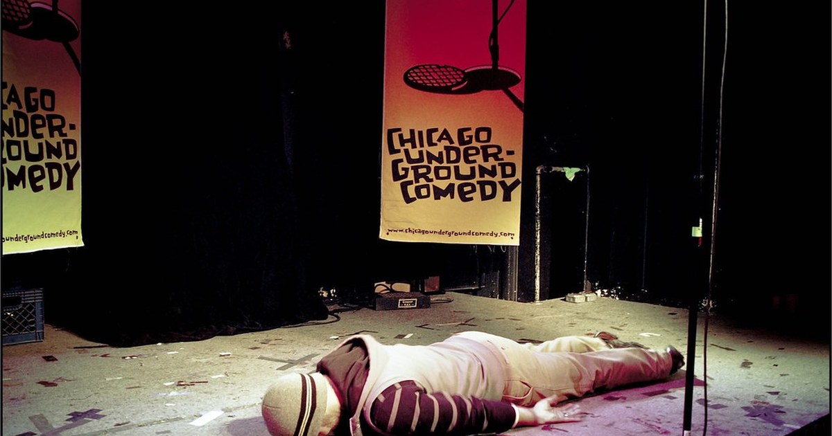 Stand-up comedy stage microphone under warm club lights