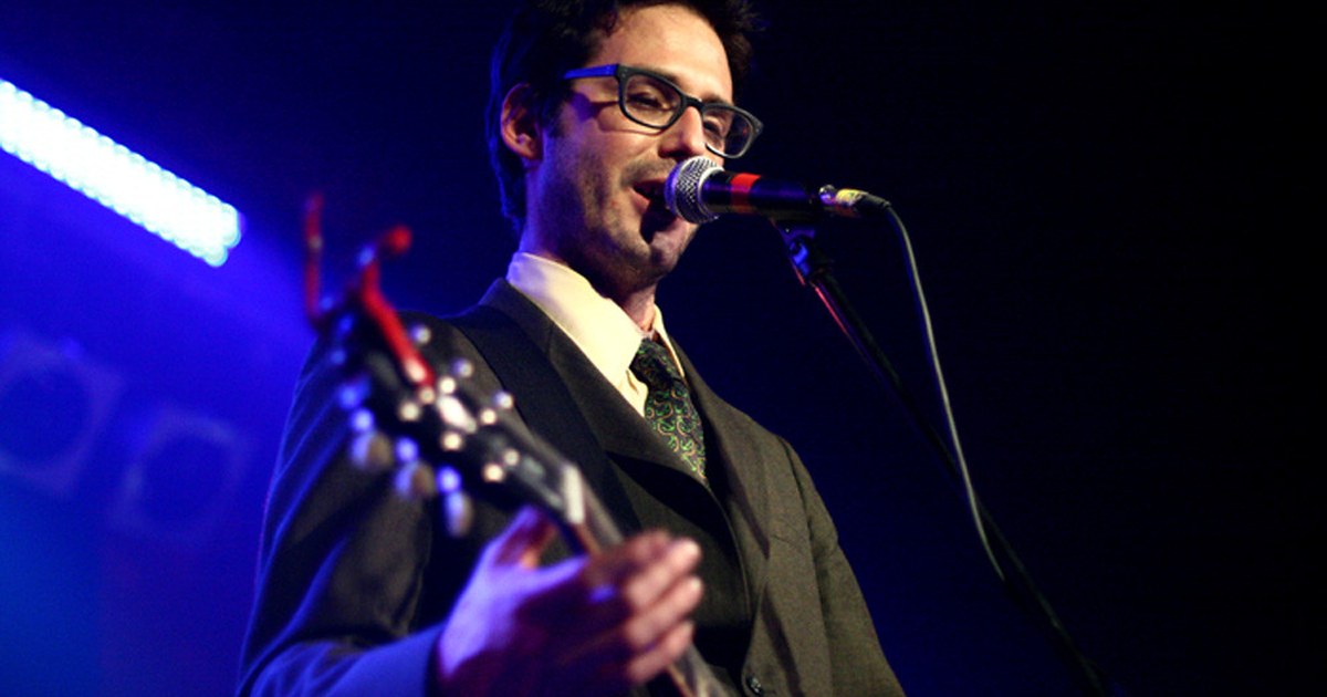 Singer-songwriter performing in a small seated music room