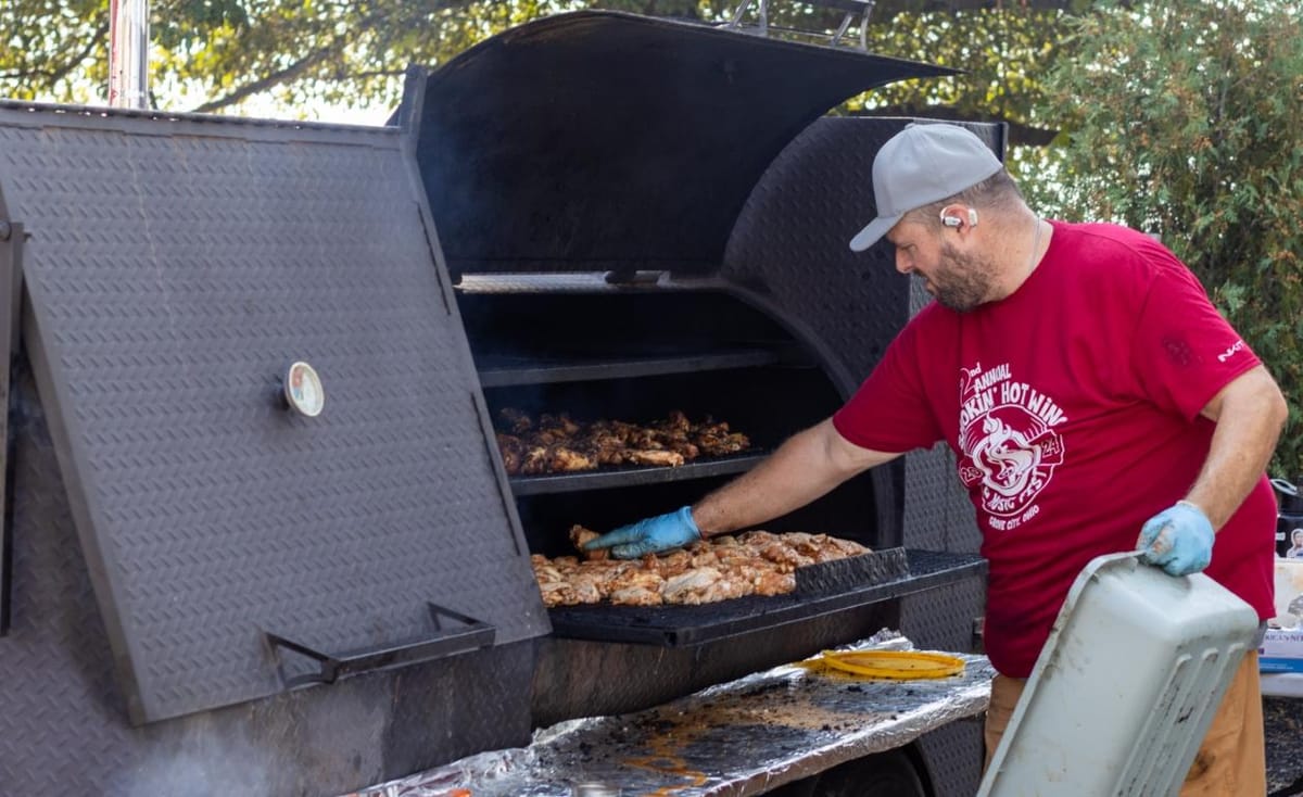 Outdoor wing festival and live music stage at a city park