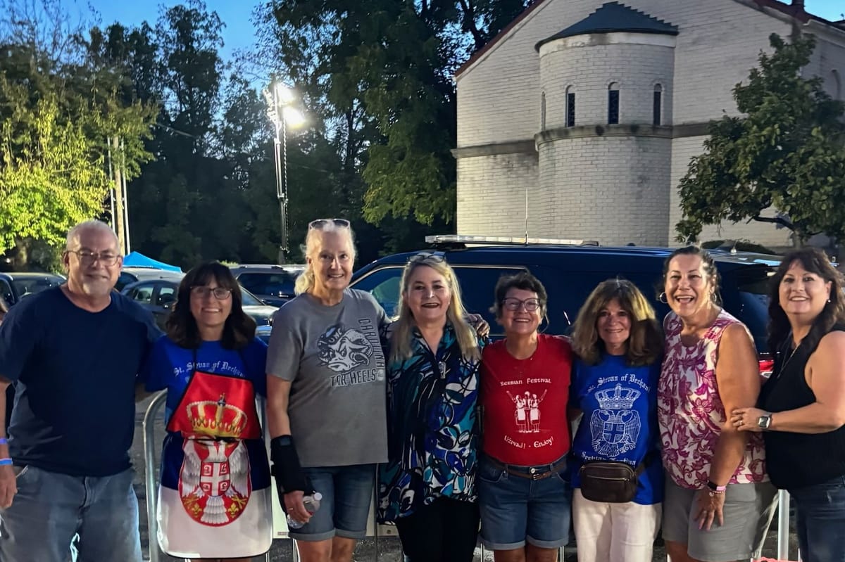 Festival volunteers in Serbian Festival shirts outside St. Stevan of Dechani Church in Columbus