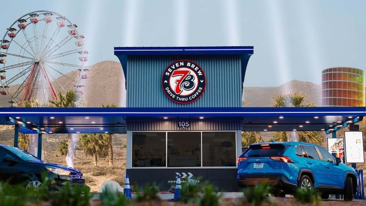 Blue 7 Brew drive-thru coffee stand with circular Seven Brew logo and dual service lanes