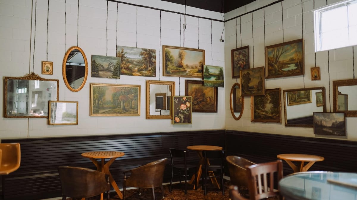 Sweet Harmony Canal dining room with gallery wall, round tables, and leather chairs in Canal Winchester