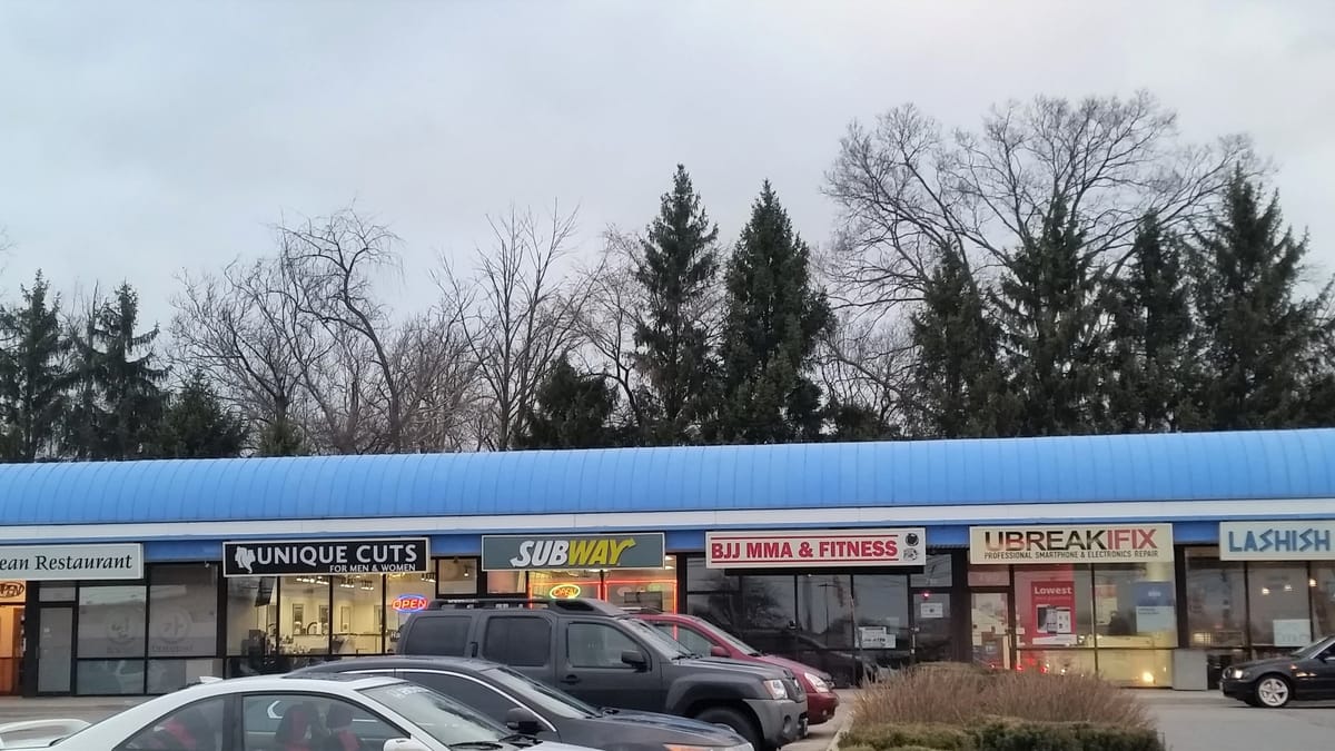 Bethel Road strip plaza in Northwest Columbus with Korean and Greek restaurant storefronts
