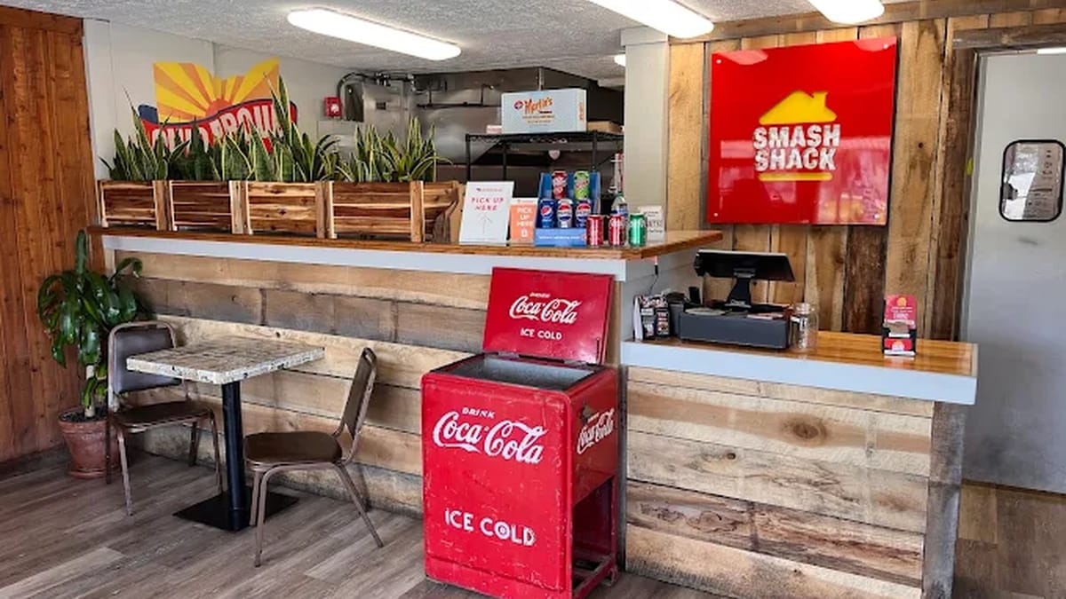 Smash Shack interior with wood-paneled order counter, vintage red Coca-Cola cooler, and red Smash Shack wall sign at the Delaware location