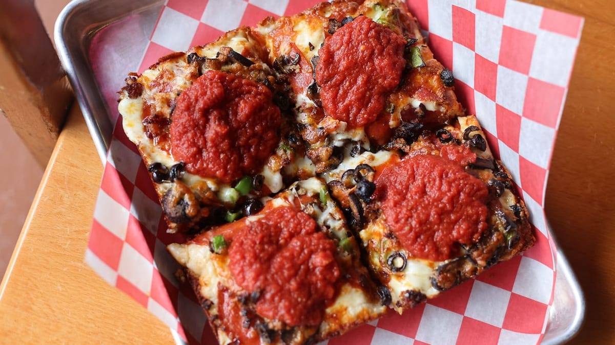 Detroit-style thick-crust pizza with sauce on top in a metal tray, Pie of the Tiger style