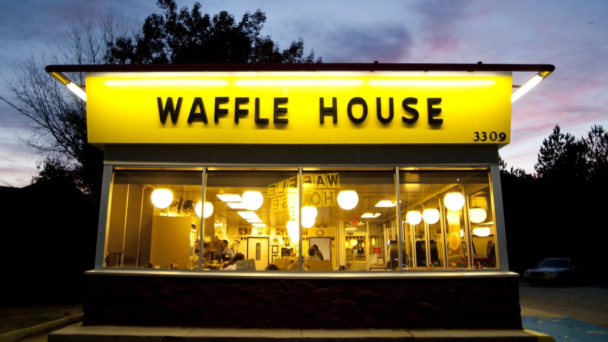 Waffle House exterior at dusk with lit yellow sign and glowing interior, from the official Polaris Parkway locator listing photo