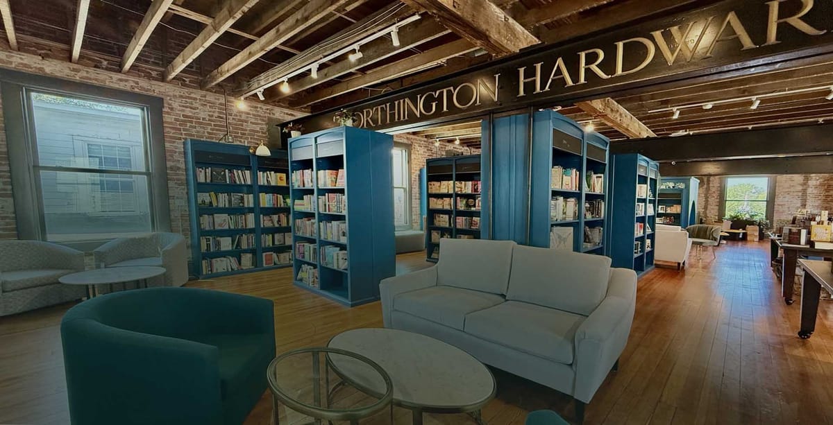 Upstairs seating and bookshelves inside The Whispering Page bookstore cafe in Worthington
