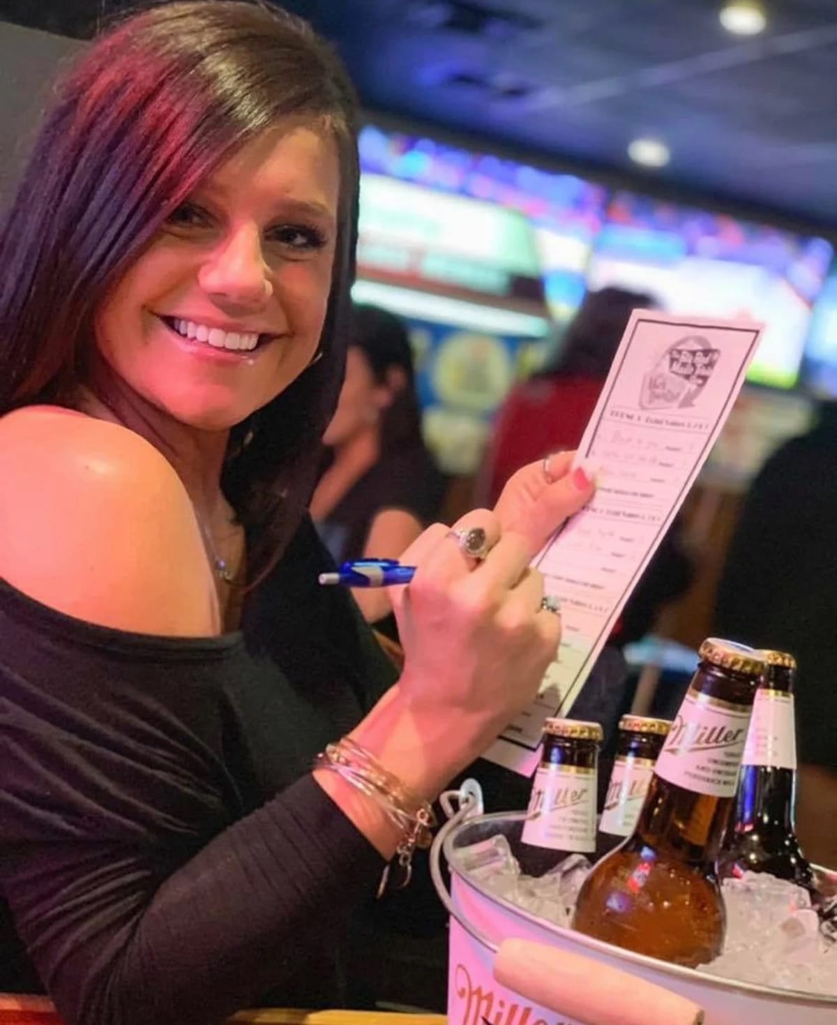 Player holding a Big Bad Music Trivia answer sheet with Mark Dantzer branding