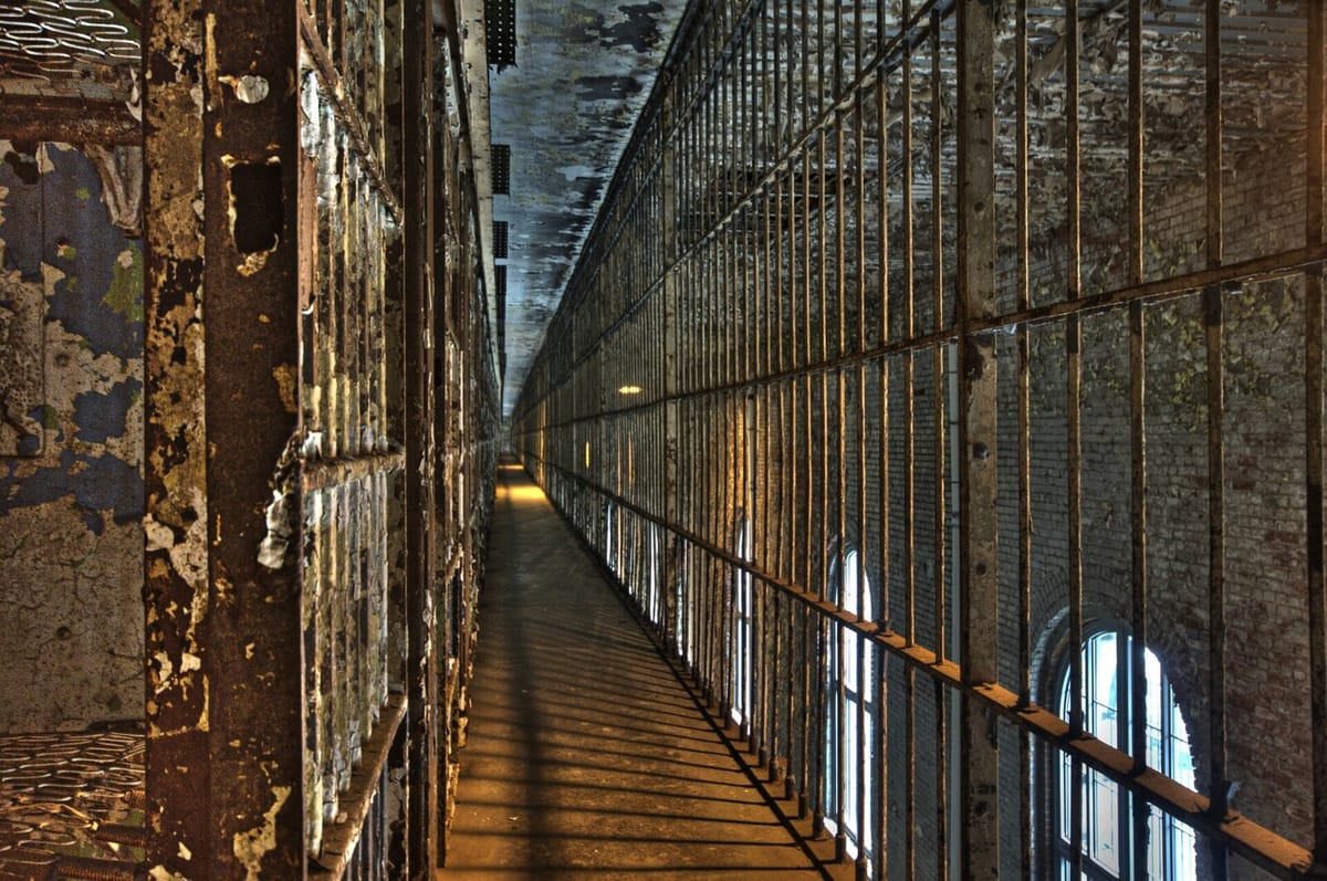 Long upper tier of the steel cell block inside the Ohio State Reformatory with peeling paint and arched windows