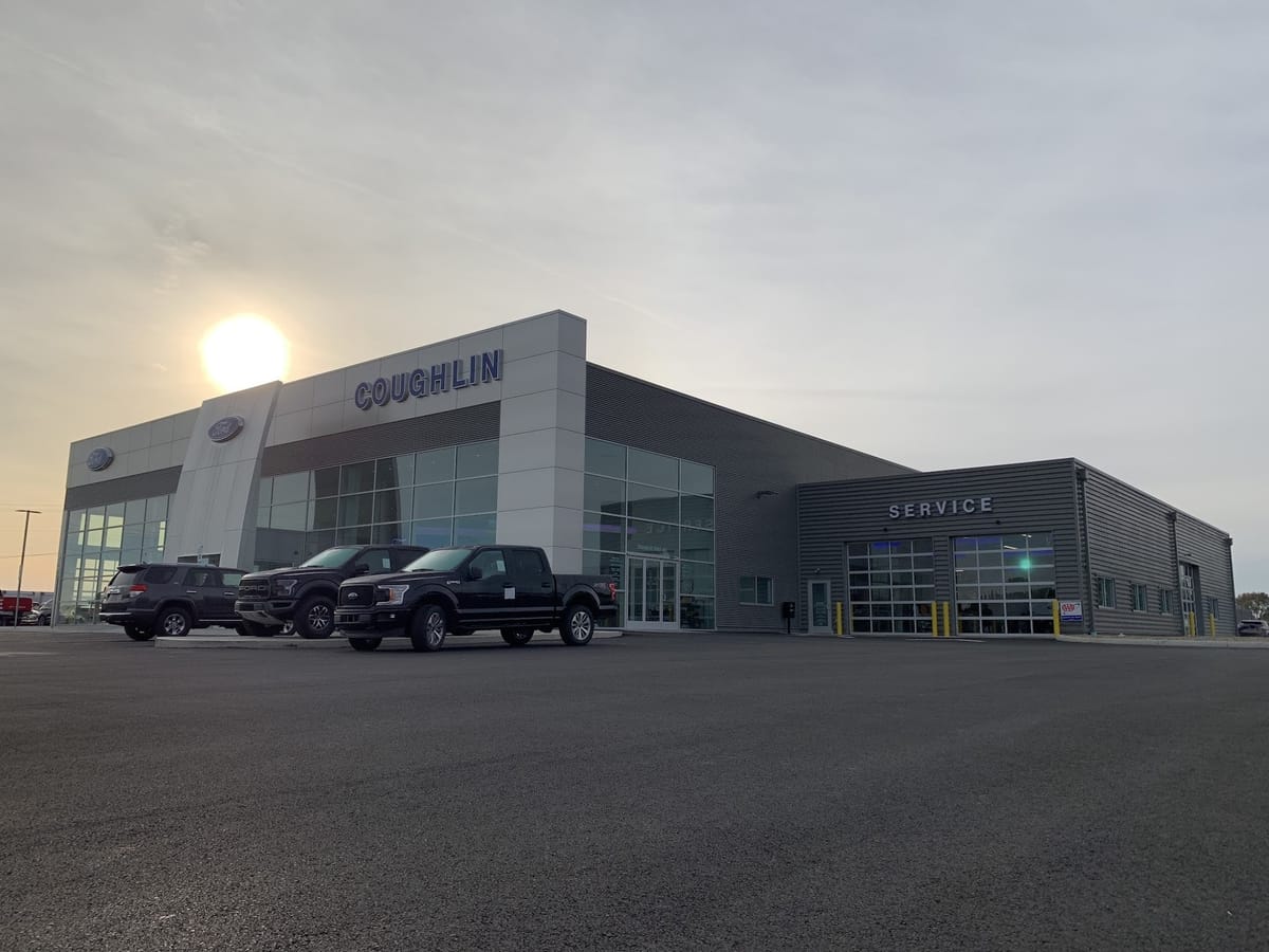 Coughlin Ford of Pataskala showroom and service building with Fords on the lot