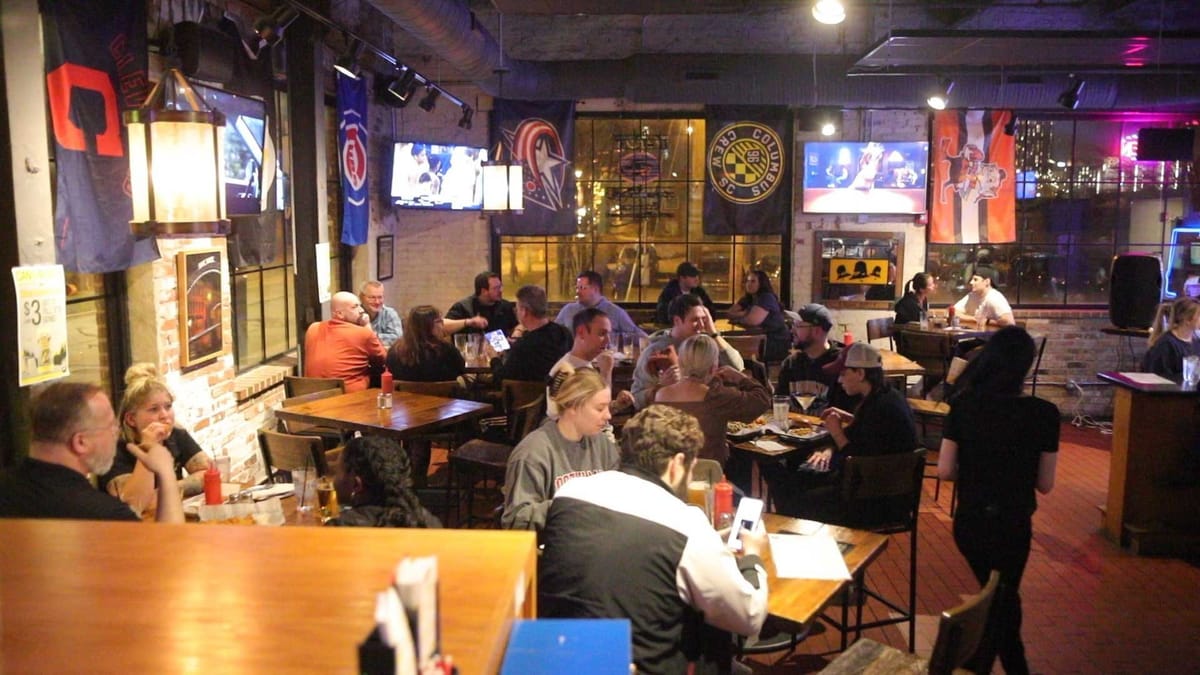 Crowded Columbus tavern interior during a trivia night