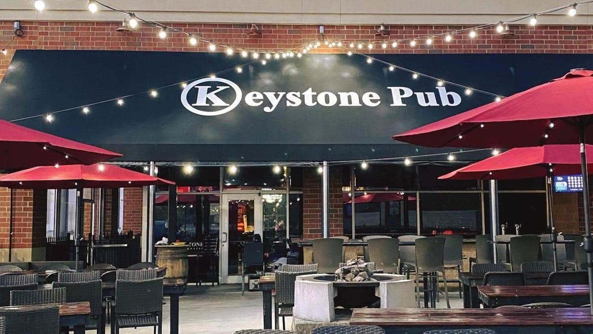 Keystone Pub & Patio exterior patio with red umbrellas