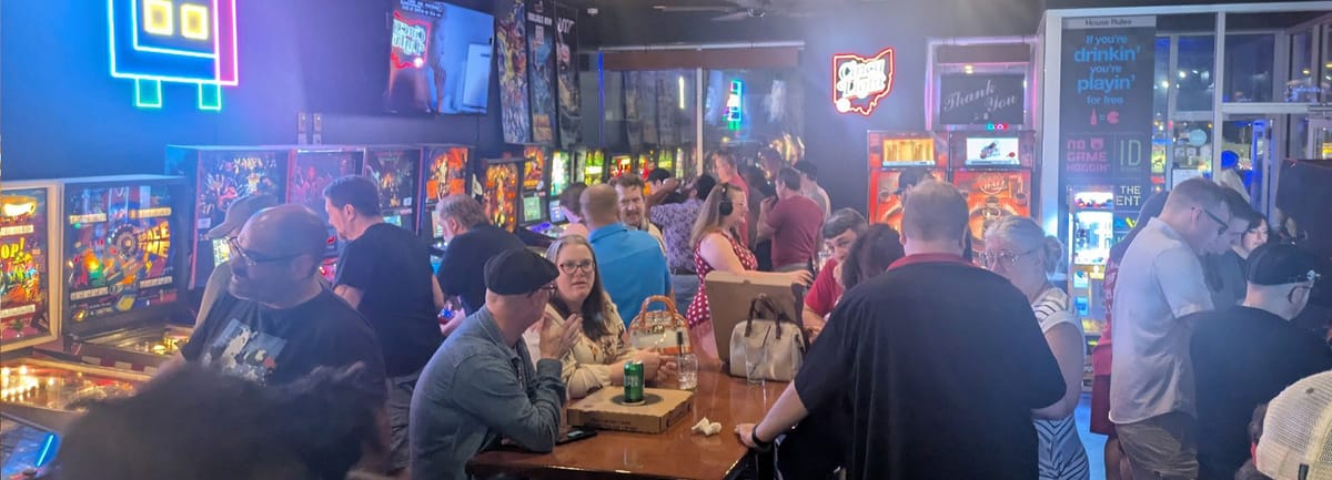 Crowded pinball and arcade floor at Level One Bar + Arcade Short North