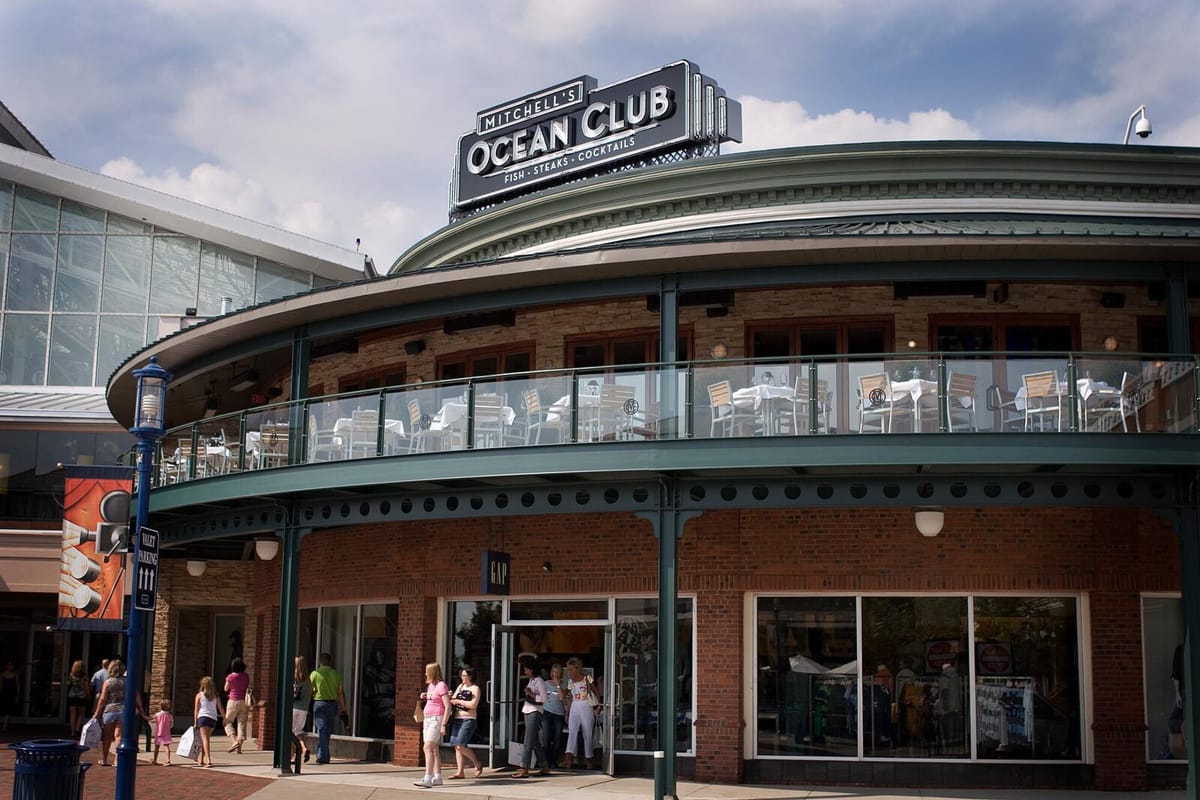 Mitchell's Ocean Club exterior and patio overlooking Easton Town Center