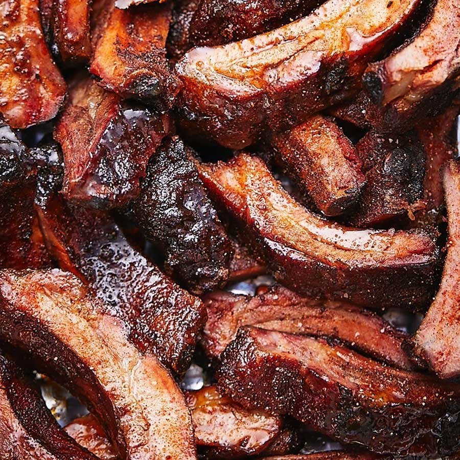 Pile of smoked pork ribs with dark bark