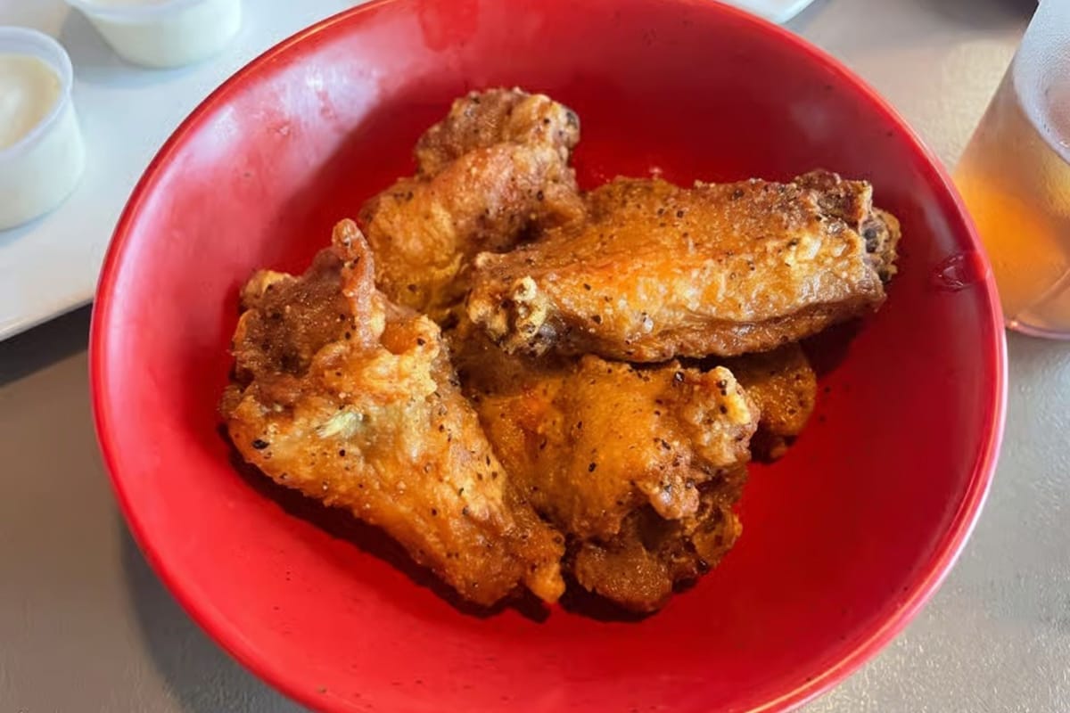 Roadhouse Wings & Grille bone-in wings in red bowl with ranch