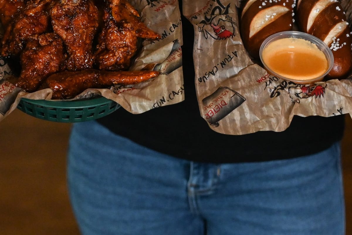 Roosters traditional bone-in wings in green basket